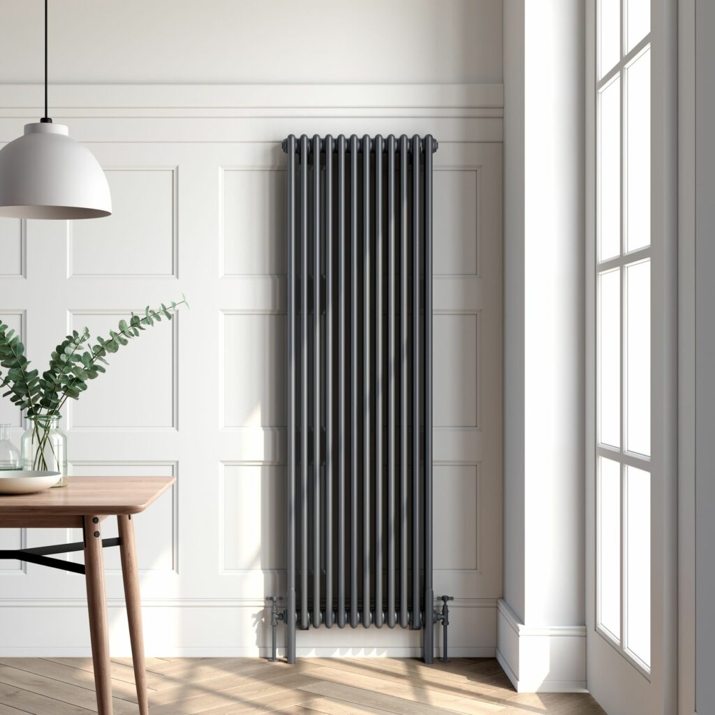 tall radiator in a white room with a brown herringbone floor