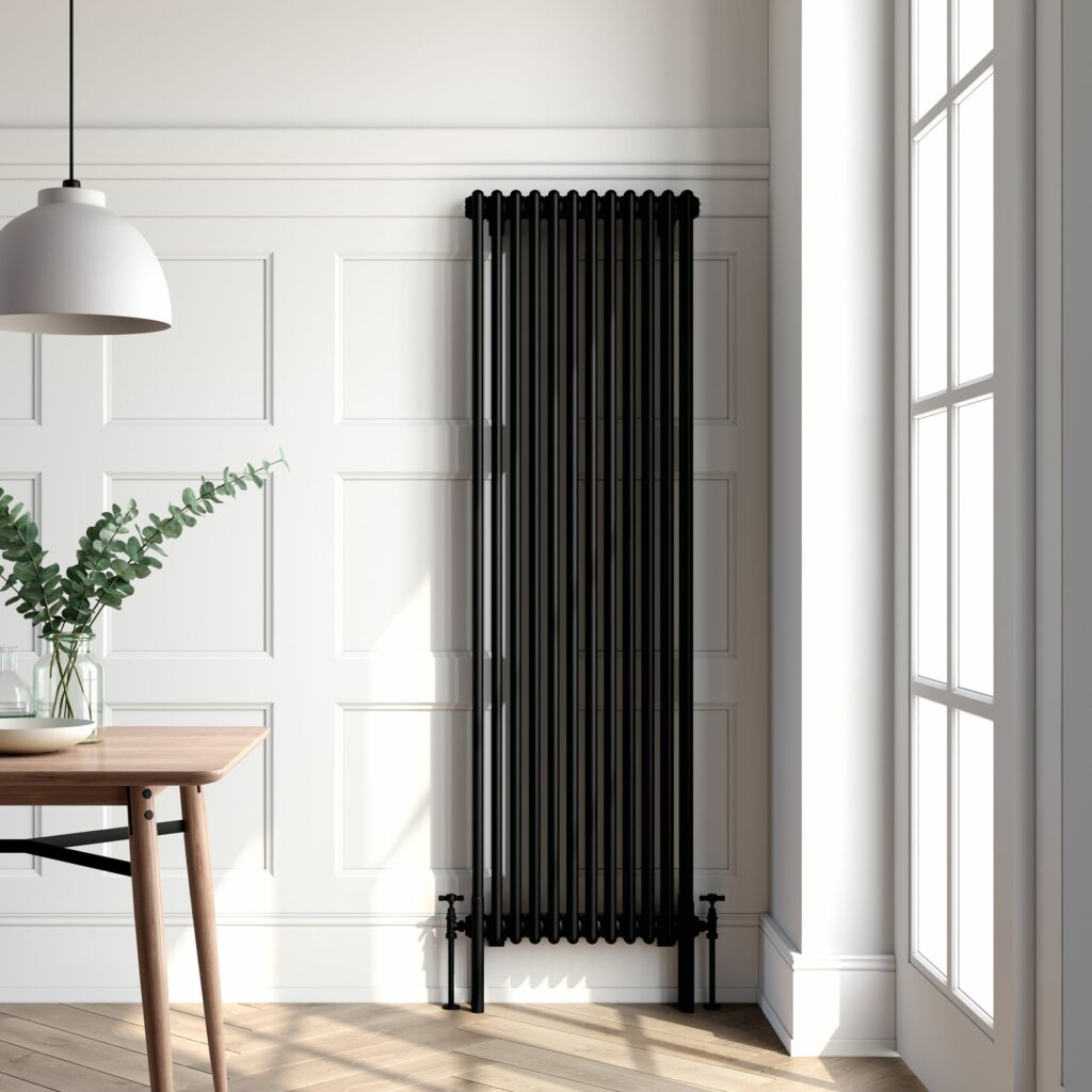 black radiator in a white room with a brown herringbone flooring