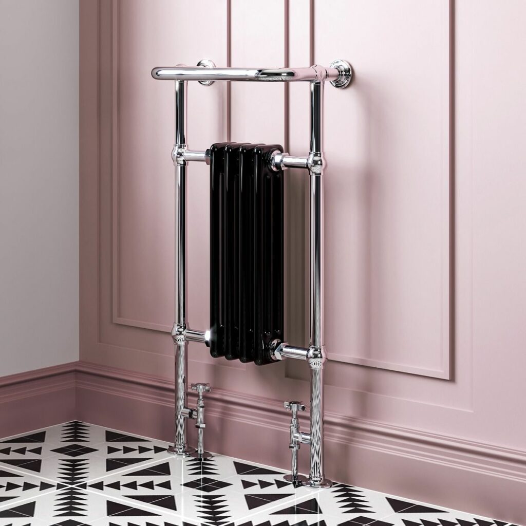 small traditional black and chrome radiator in a pink room with a geometric monochrome flooring