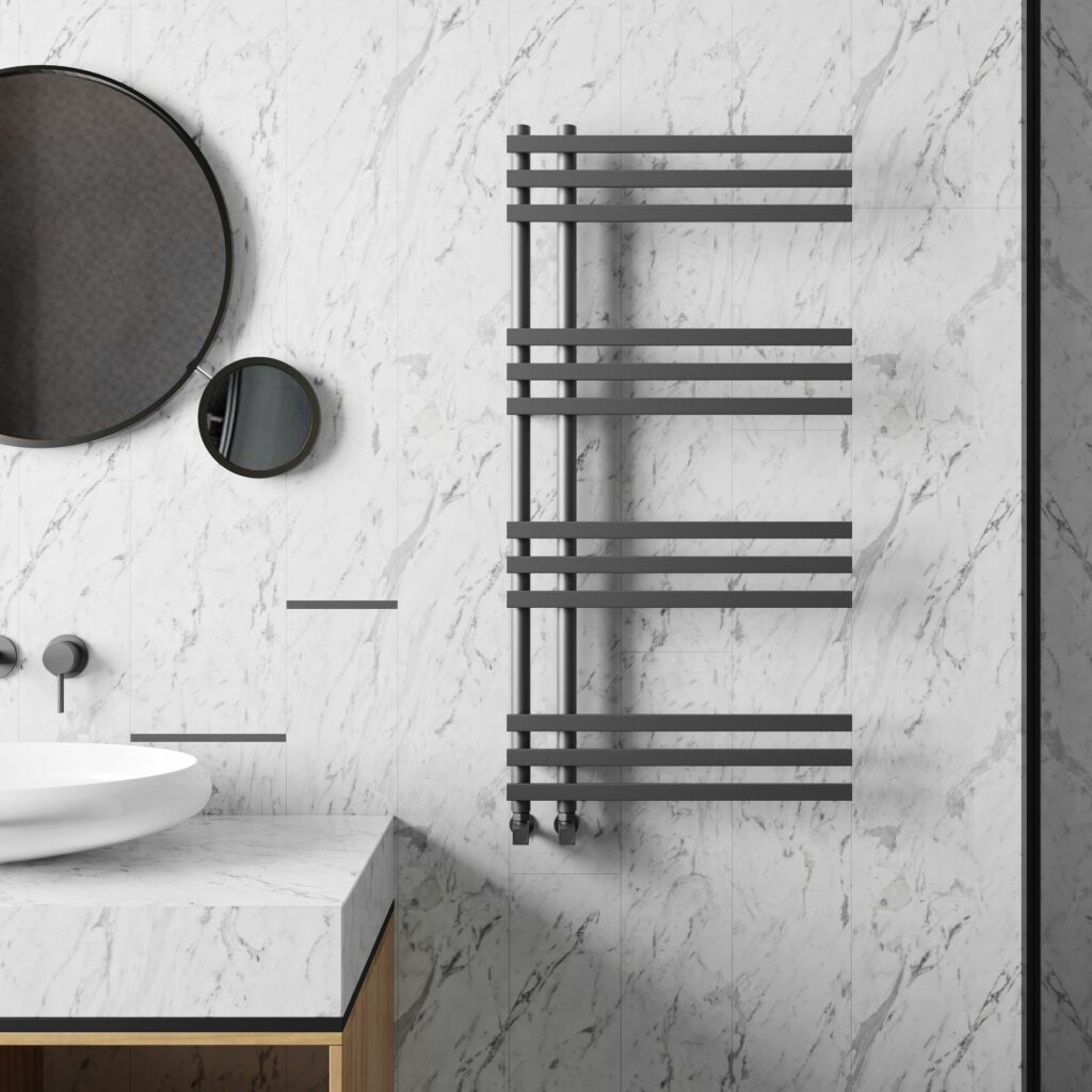 Grey towel rail against white marble tiles