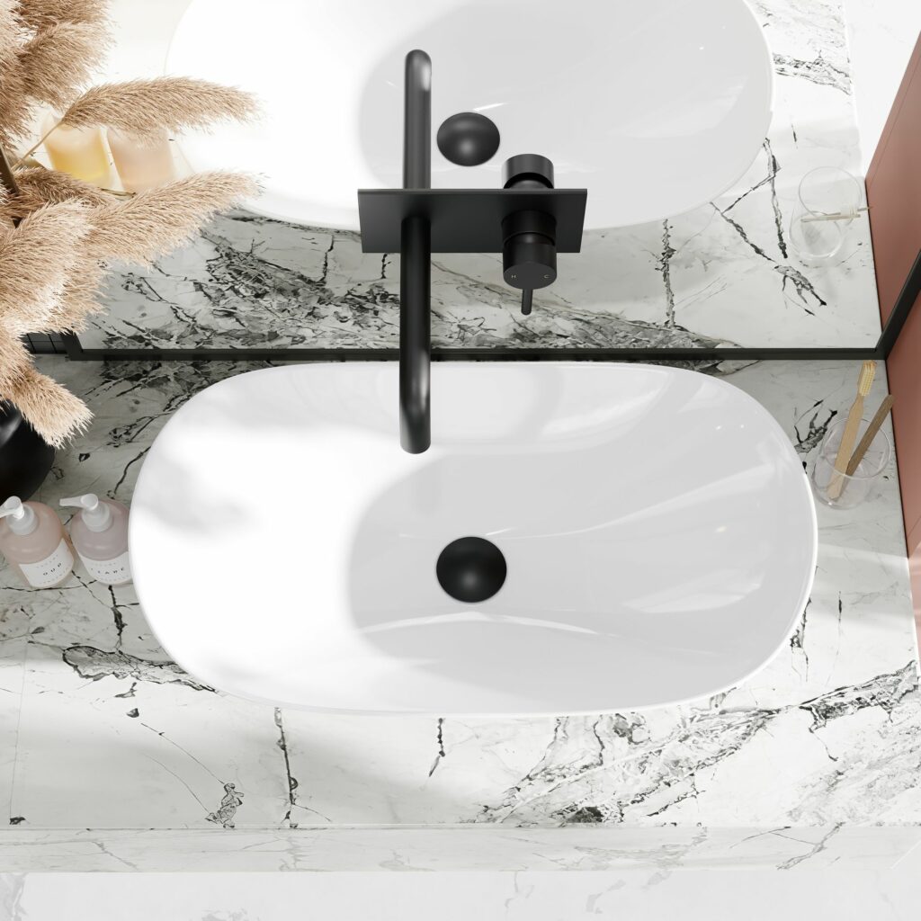 white basin with black tap and plug on marble counter top