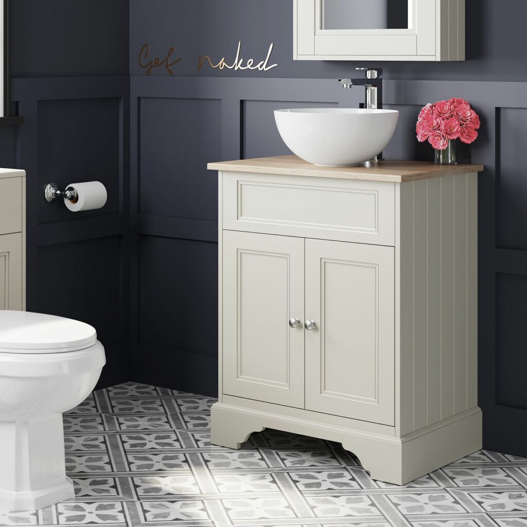 cream coloured vanity with oak top and  round white countertop basin