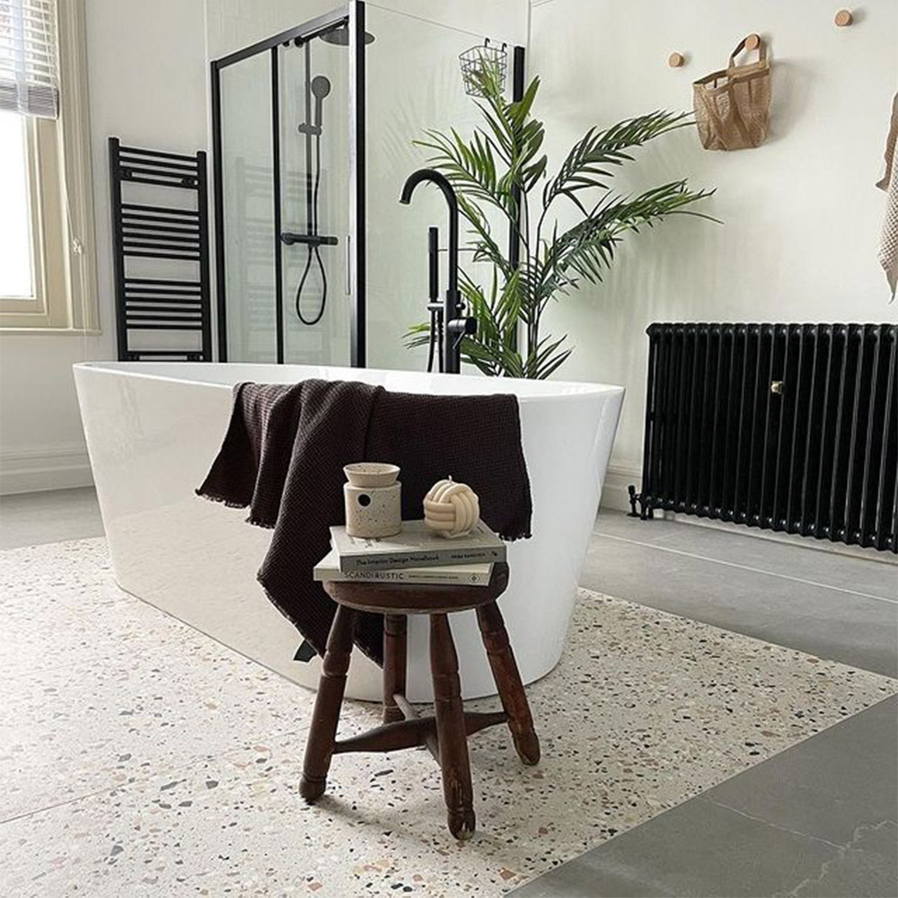 matt black lined glass shower enclosure and white acrylic freestanding bath 